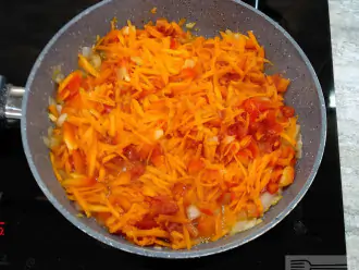 Шаг 5: Поставьте на огонь сковородку с растительным маслом.
Когда нагреется выложите в нее лук, чеснок и болгарский перец. А также порезанные помидоры и натертую на крупной терке морковь.
Помидоры можете взять как свежие, так и консервированные в собственном соку.