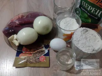 Шаг 1: Подготовьте ингредиенты: ржаную и пшеничную муку, воду, яйцо, подсолнечное масло, соль, мясо гуся, лук, чеснок и специи.