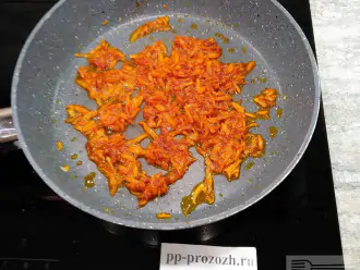 Шаг 5: Морковь почистите, помойте и натрите на крупной терке. 
Хорошо обжарьте. Добавьте томатную пасту. Протушите еще 3 минуты.