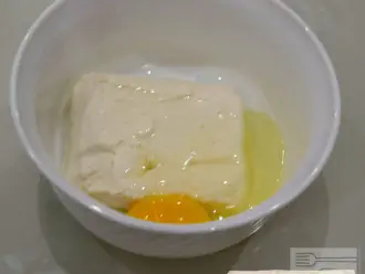 Шаг 2: В творог добавьте яйцо.