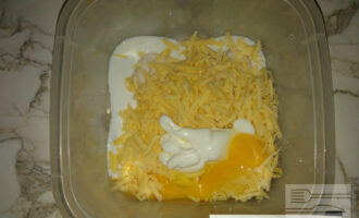 Шаг 3: Добавьте к сыру яйцо, молоко и йогурт и тщательно все перемешайте.